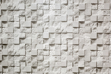 Wall plastered in the form of repeating squares mosaic, 3D texture. The gray background of...