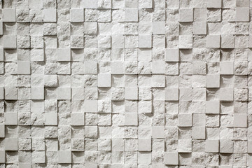 Wall plastered in the form of repeating squares mosaic, 3D texture. The gray background of decorative stucco squares. Textured Wallpaper.