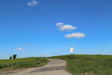 Spring landscape with a road going into the sky