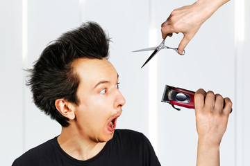 long hair freak crazy man hold scissors and trimmer and guy want cut his hair at home. Concept for...