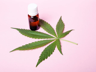 Medical cannabis product.Concept: natural hemp extract on pink background