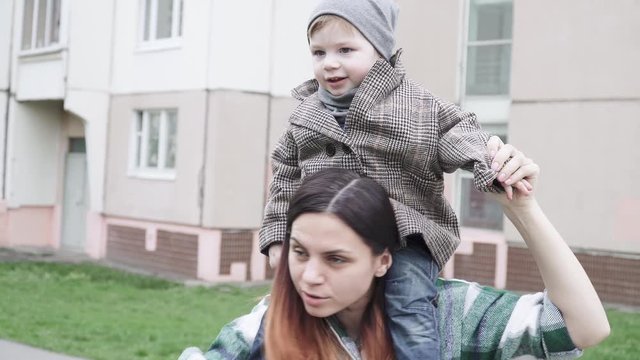Boy child in a coat on mom