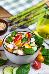 Concept of healthy food, clean eating, dieting. Colorful fresh vegetable salad in bowl. Easy to cook, perfect summer light meal. Source of vitamins in summer season. Wooden background close up macro