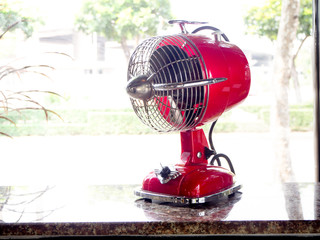 red fan on a wooden table in cafe