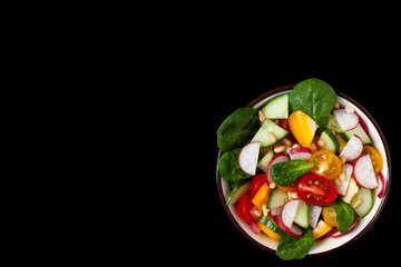 Concept of healthy food, clean eating, dieting. Colorful fresh vegetable salad in a bowl. Easy to cook, perfect summer light meal. Black background copy space for text and design