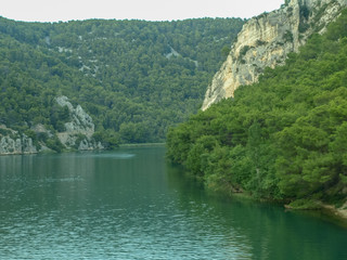 Small lake  in the green summer forest with turquoise water