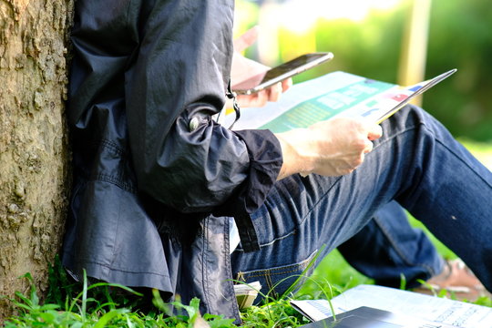 Young Person Reading A Newspaper