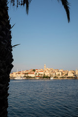 Korcula island with the old city walls, view from the sea on a sunny day during sunset. Clear adriactic sea, the south mediterranean coast of Croatia Europe. Beautiful seascape