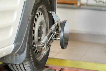 Performing wheel alignment works at the service station.