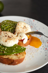 Hhomemade toast with avocado, eggs, tomato and seeds