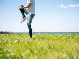 膝を抱えてストレッチをする人