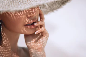 Portrait of a beautiful woman in a straw hat with french manicure. Cosmetics,makeup and beauty. Spa. Copy space © Detkov D