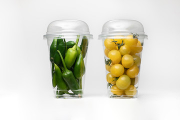 Packaging with green pepper and tomato on white background. Isolated white background. Tomatoes isolated.