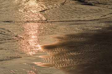 water and wet rippled sand at the beach at sunset background, Adriatic sea in Italy Italy
