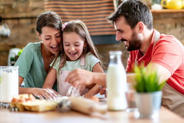 Family makes a cookie in the kitchen