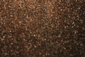 Dark golden and brown abstract bokeh lights. defocused background