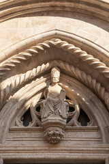 The st Mark in the doorway of the Cathedral at the town of Korcula island, Dalmatia, Croatia. Beautiful gothic elements. Old architecture, exterior, facade made of limestone, detail shot