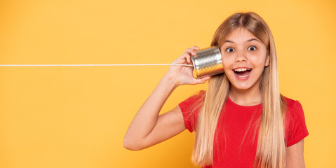 Portrait girl happy and surprised with tin can phone