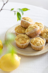 Corn muffins with lemon and honey on a white table. Homemade recipe, bakery. Healthy nutrition