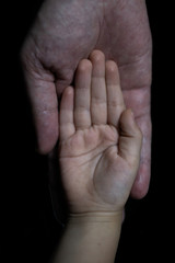 Fototapeta premium Father and son holding hands. Helping hands
