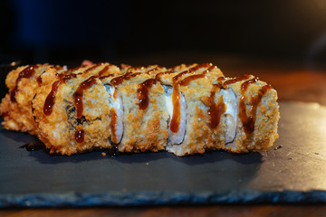 A set of sushi. Philadelphia roll, California, unagi, black dragon with fresh ingredients. The sushi menu. Japanese cuisine. Ginger and wasabi. Soy sauce. Sesame. Hot, baked, breaded