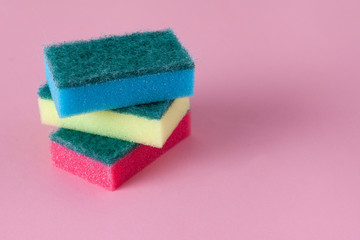 Kitchen cleaning sponge on pink background. Stack of sponges with copy space. 