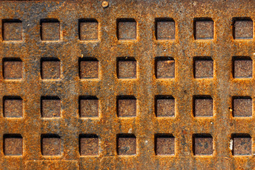Fragment of an iron hatch with rust and rectangular elements