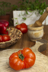 Tomato and ingredients on a wooden table