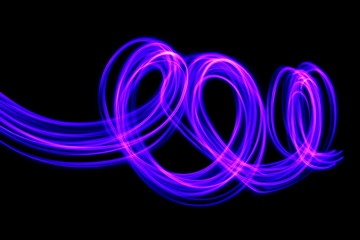 Long exposure photograph of neon purple colour in an abstract swirl, parallel lines pattern against a black background. Light painting photography.