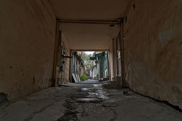 Obraz premium Slums of Russia. Old poor street in the rain. The resort city of Russia Kislovodsk. Rain in a poor quarter.