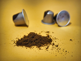 Coffee capsules on yellow background