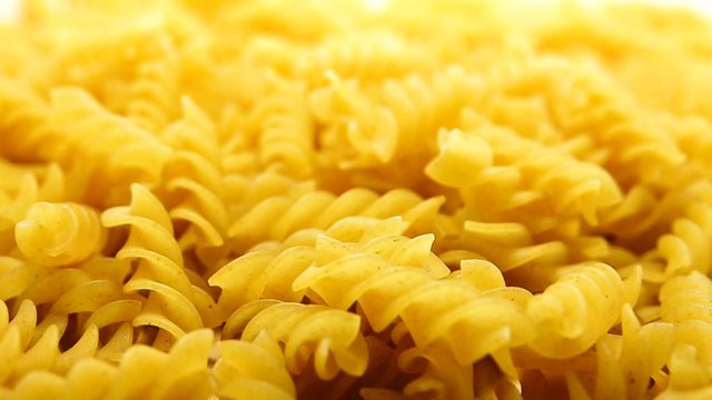1080p HD super s;ow Uncooked pasta Rigatoni and Fusilli on food background. Cooking concept. Top view