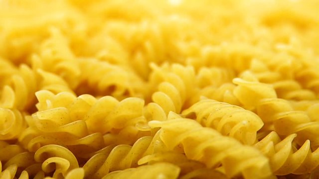 1080p HD super s;ow Uncooked pasta Rigatoni and Fusilli on food background. Cooking concept. Top view