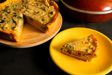 Portion of vegetable and cheese tart on a yellow plate