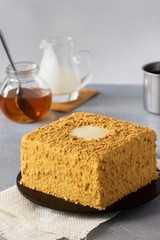 Honey cake on light grey background. Copy space.