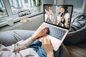 Attractive young girls on a laptop screen. Young girl communicates via video conference with her...