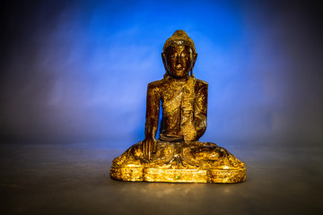 Golden Buddha in blue background