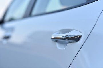 handle of white business car in winter