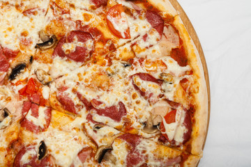 Pizza on a wooden board on a white background