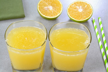 Sweet lime juice in glass cups with sweet lime fruits in the background