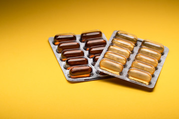 omega 3 supplement package and capsule lecithin sealed with yellow background