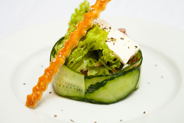 Salad with cucumber greens and a stick