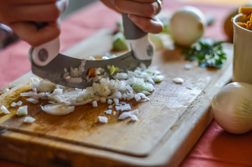 mincing onions very small while preparing food in the kitchen