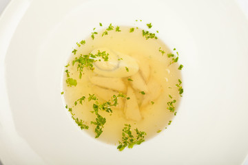Soup with egg and meat, on a large white plate, white background