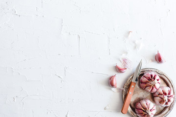 Garlic on a white plaster surface