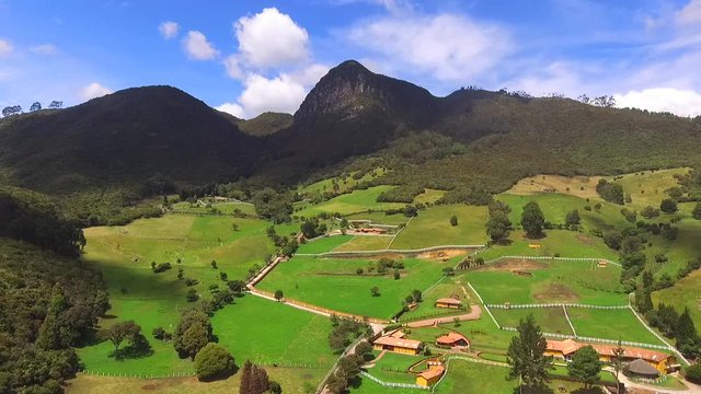 High mountains of mythical figures, trees and a clear sky all in Tabio