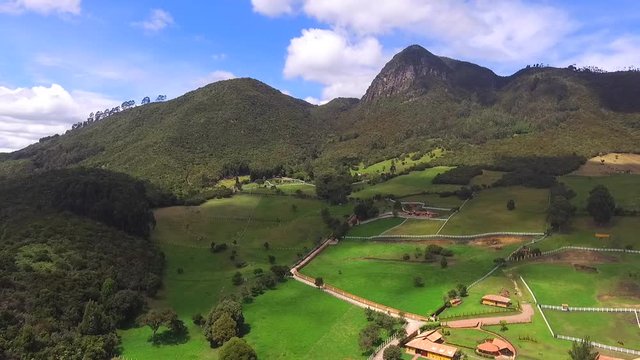 High mountains of mythical figures, trees and a clear sky all in Tabio