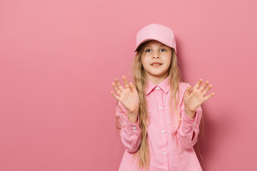 Little girl in pink clothes on a pink background