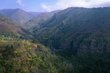 Limestone rock precipices in front of green valleys at Courel Mountain Range Geopark