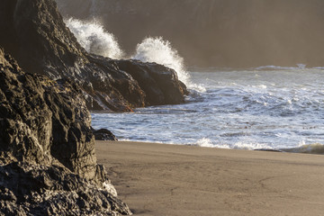 Waves crashing on a rock in Secret Beach, Oregon